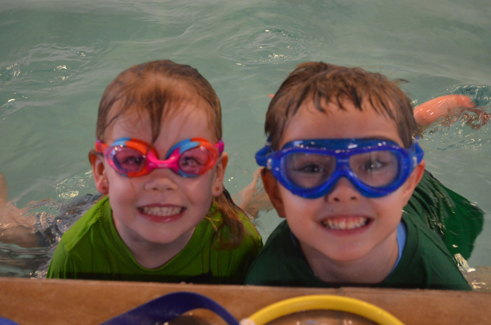 Children smiling in colourful goggles at Little Pearls